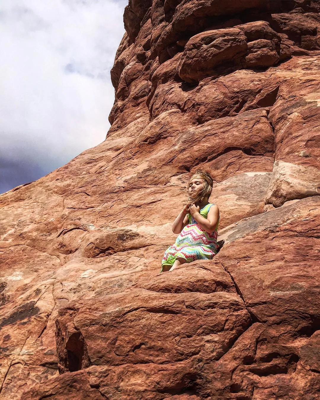 Emerson rests against a large red sandstone formation.
